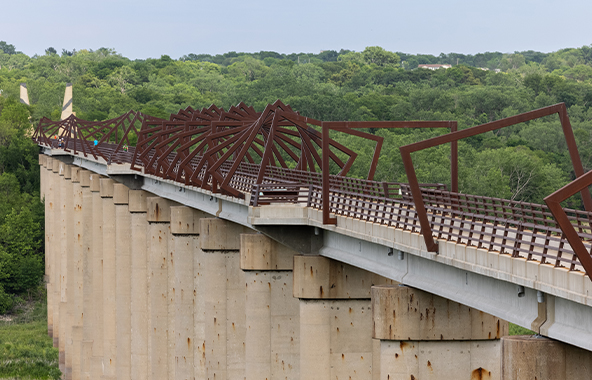 High Trestle Trail Bridge overlooking a wooded Iowa landscape.