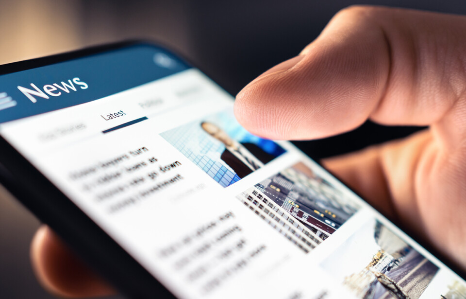 Person reading news on a smartphone.